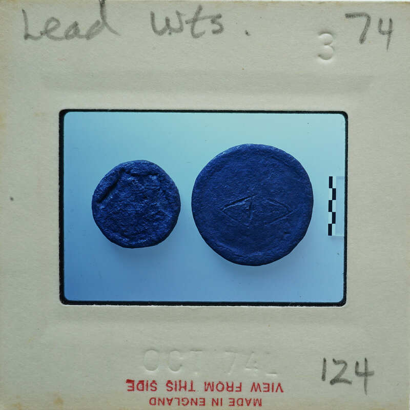 Two dark circular metal objects on blue background.