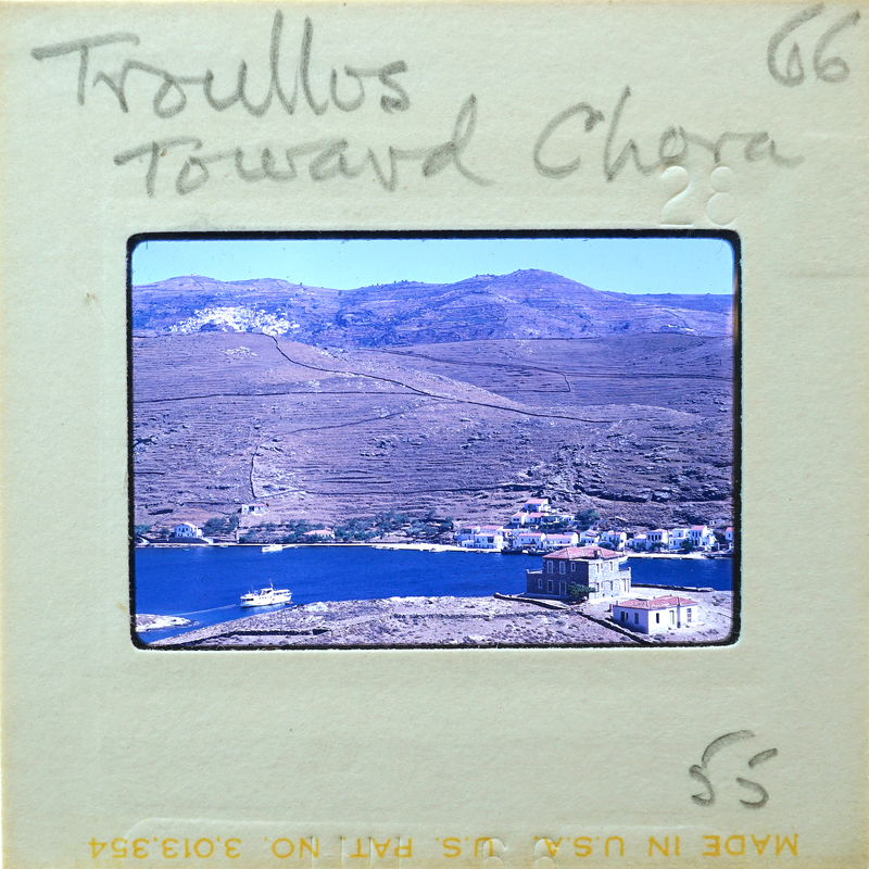 Picture of a scenic landscape with mountains, water, and buildings on a vintage film strip.