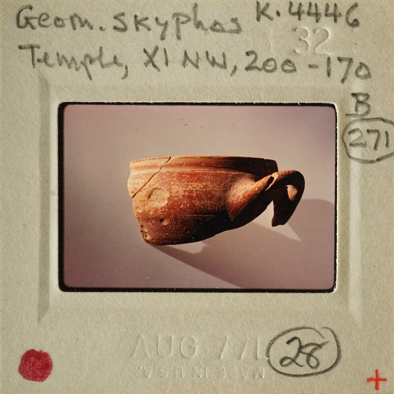 Small ancient Greek pottery artifact on display.