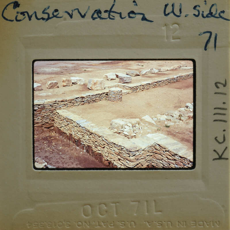 Old photograph of a stone structure with ruins, possibly an ancient site.