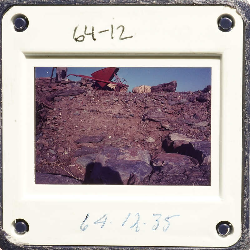 Rocky terrain with scattered debris and a clear sky.