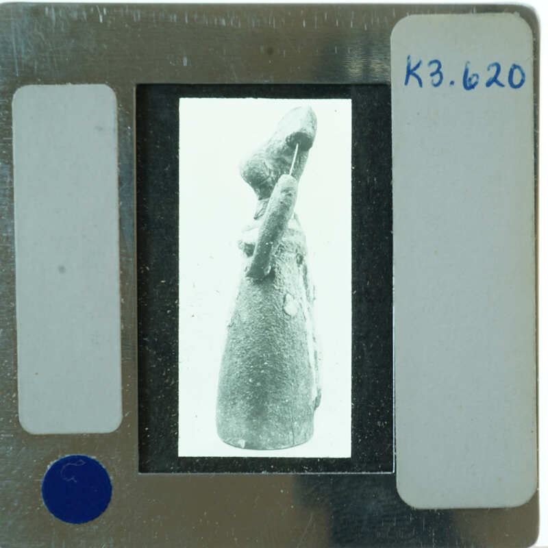 A black and white image of a sculpture on a film strip with labels.