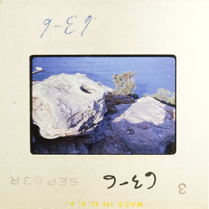 Rocky shoreline with water in the background.