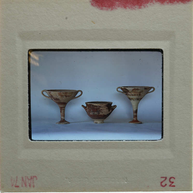 Three reassembled pots. A kylix on each side of a bowl in profile.