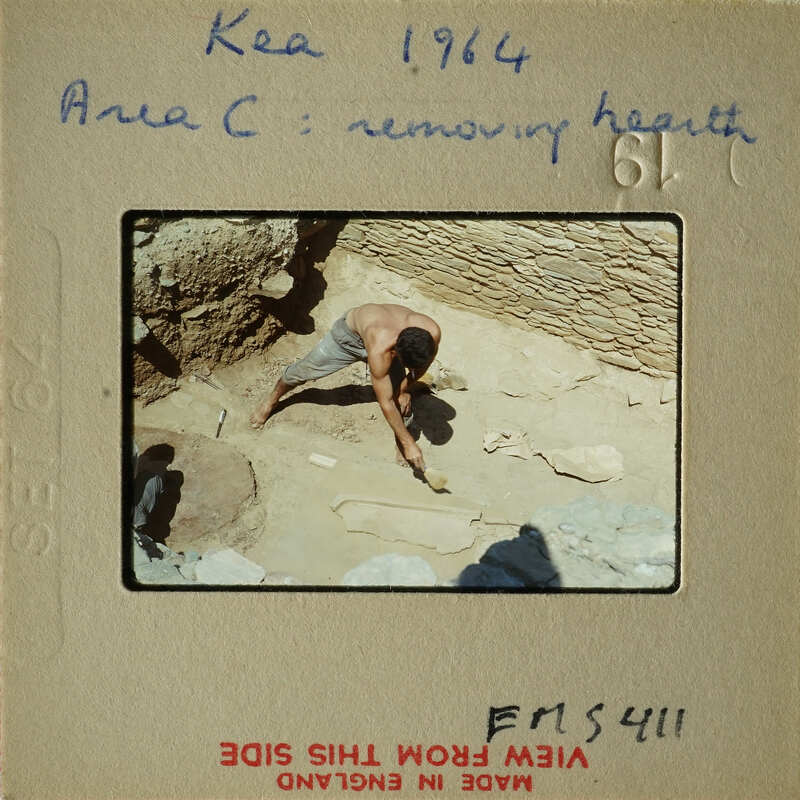 Man working on stone structure with tools.