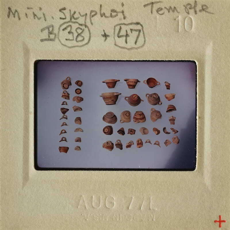 Photograph of ancient pottery shards and fragments on display.