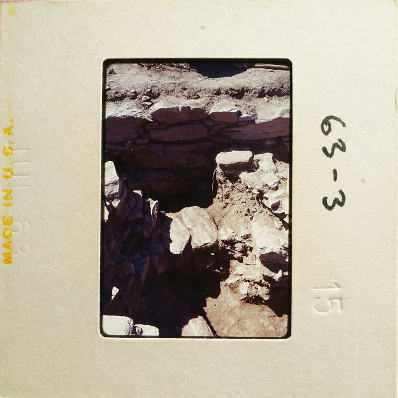 A photograph of an archaeological site with ancient ruins and rocks.