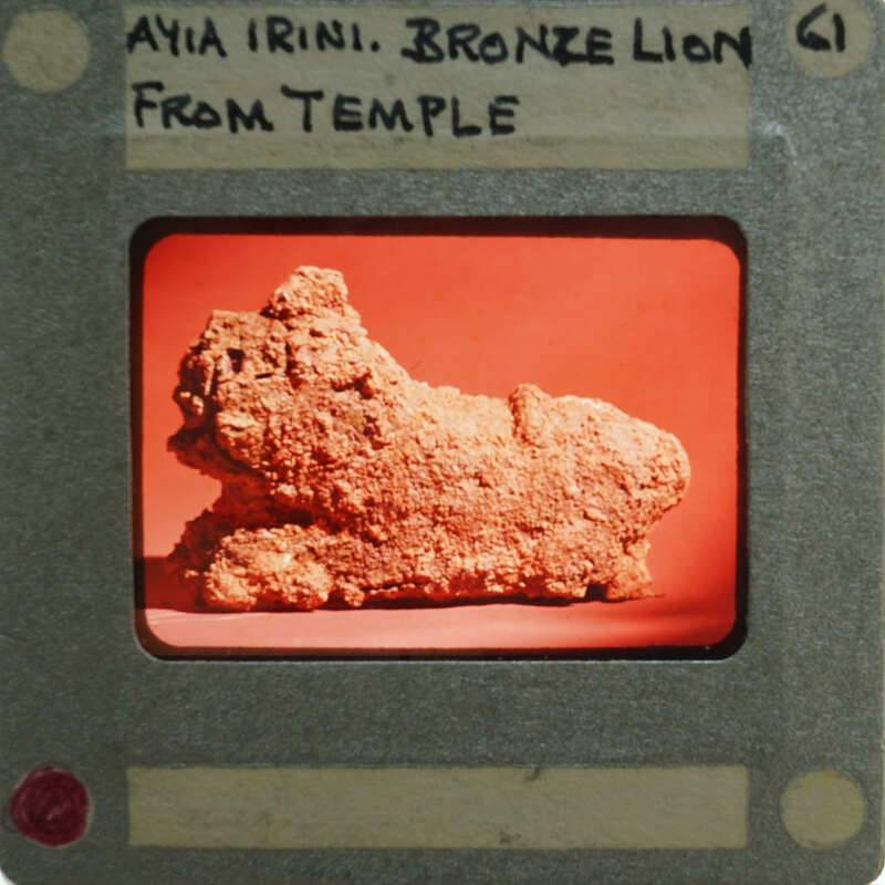 A photograph of a bronze lion figurine on a film strip with text.