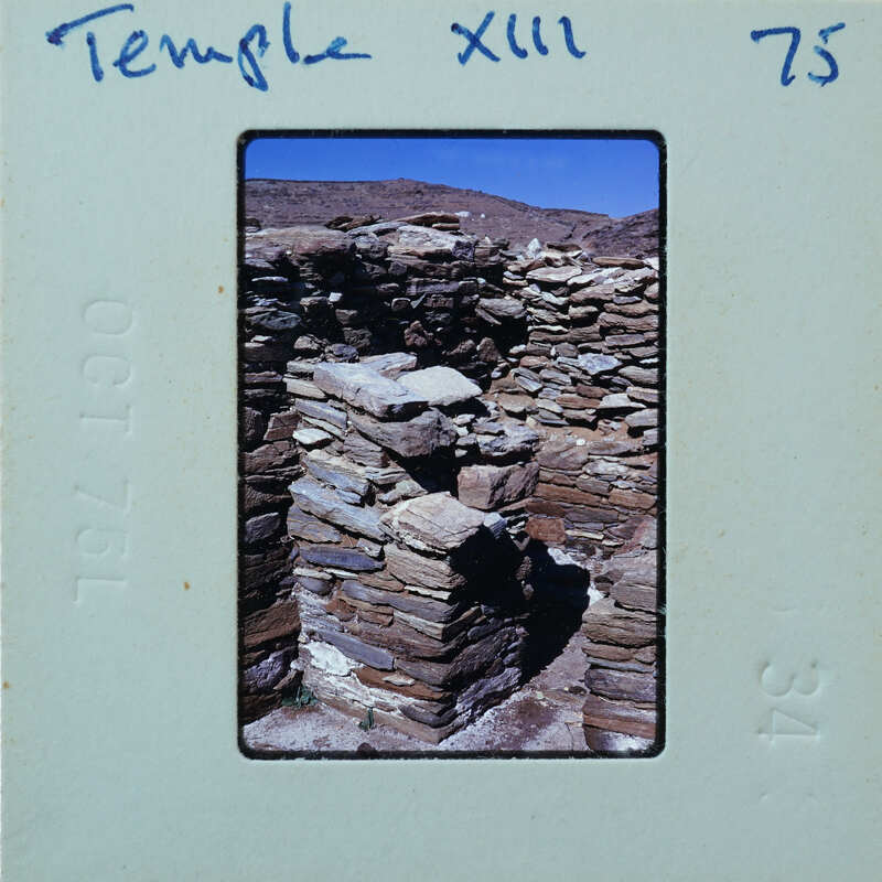 Stone ruins of an ancient temple with a blue sky background.