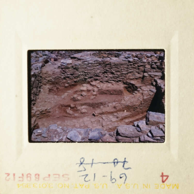 This is an old photograph depicting an archaeological site with stone ruins.