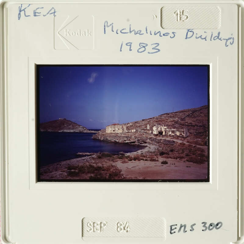 A sepia-toned photograph showing an ancient coastal settlement with ruins and water.