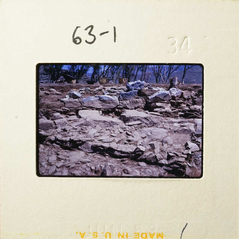 A photograph showing an outdoor scene with rocks and dirt, possibly from a historical or archaeological site.