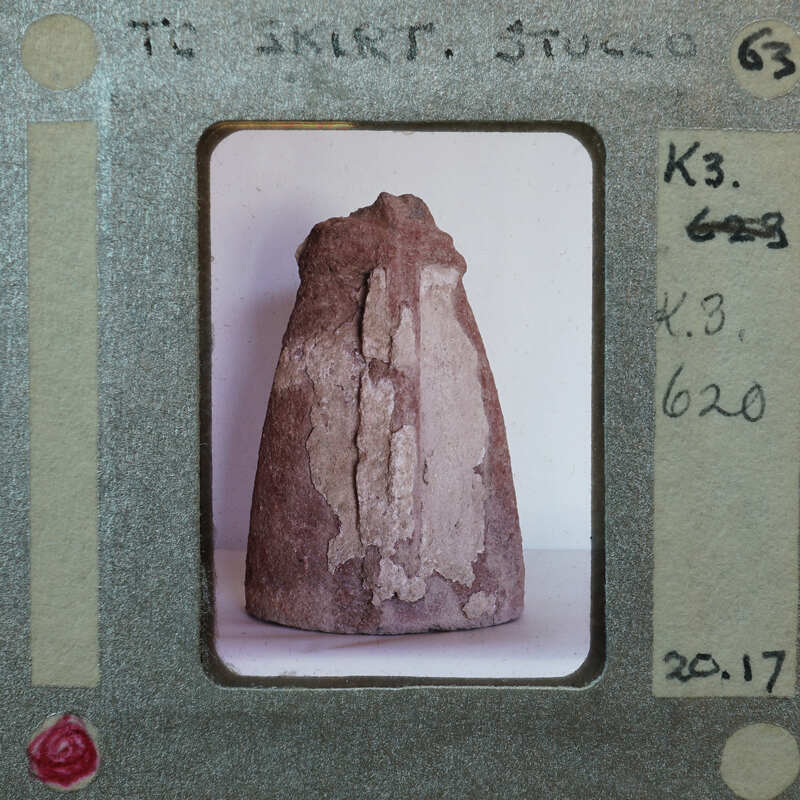 Terracotta figurine fragment of skirt with surface covering K3.620.