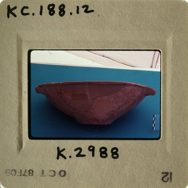 Ancient pottery bowl with visible cracks and imperfections.