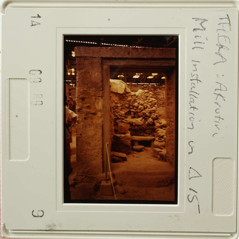 The image shows an ancient underground chamber with stone walls and columns, likely part of an archaeological site.