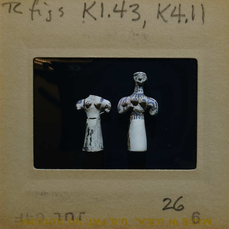 Two small reconstructed figurines showing dark paint on white surface, K1.43, K4.11.