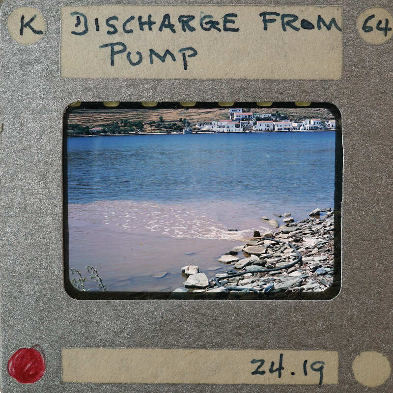 Picture of a body of water with brown sediment, possibly from a pump discharge, captured on an old film strip.