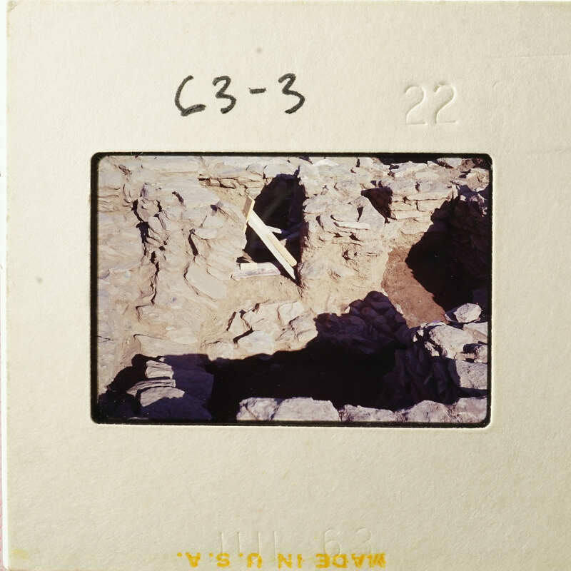 Ancient ruins with exposed stone and dirt, possibly an archaeological site.