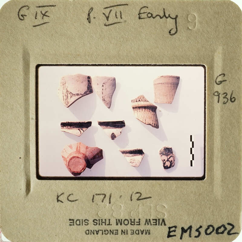 These are small, ancient pottery shards on display.