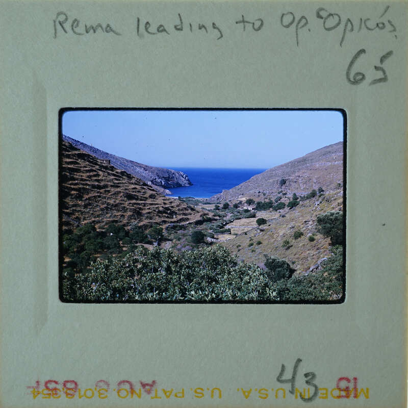 A vintage photo of a coastal landscape with mountains and water, labeled "REMA LEADING TO OPOCIOS".