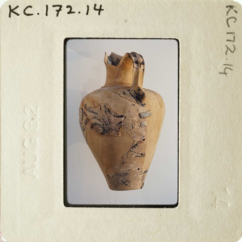 Ancient vase with intricate designs and markings, photographed on an old slide.