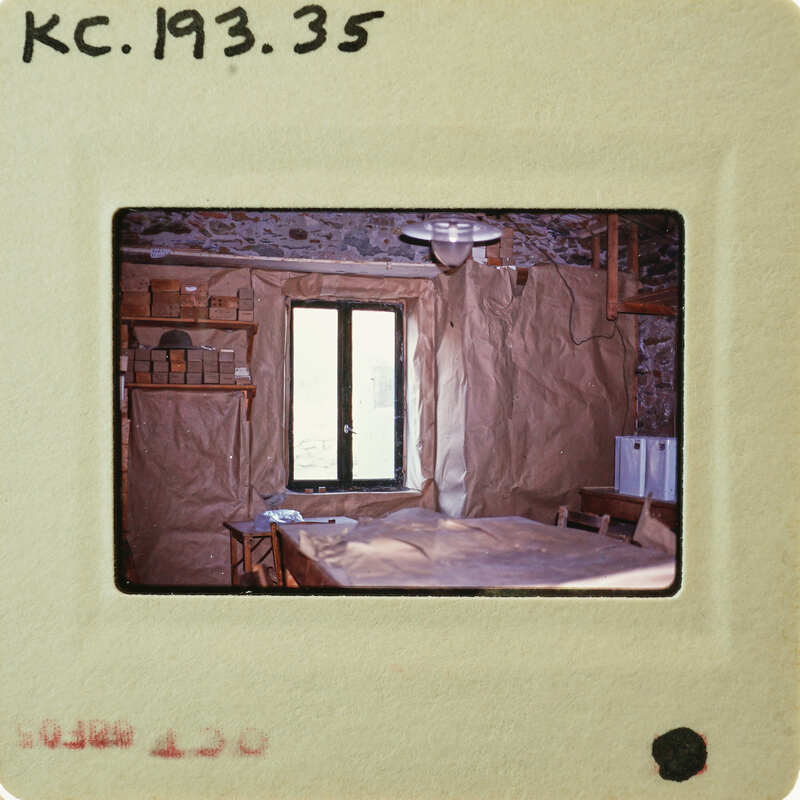 Photo of a room with a table and window, taken from another photo within it.