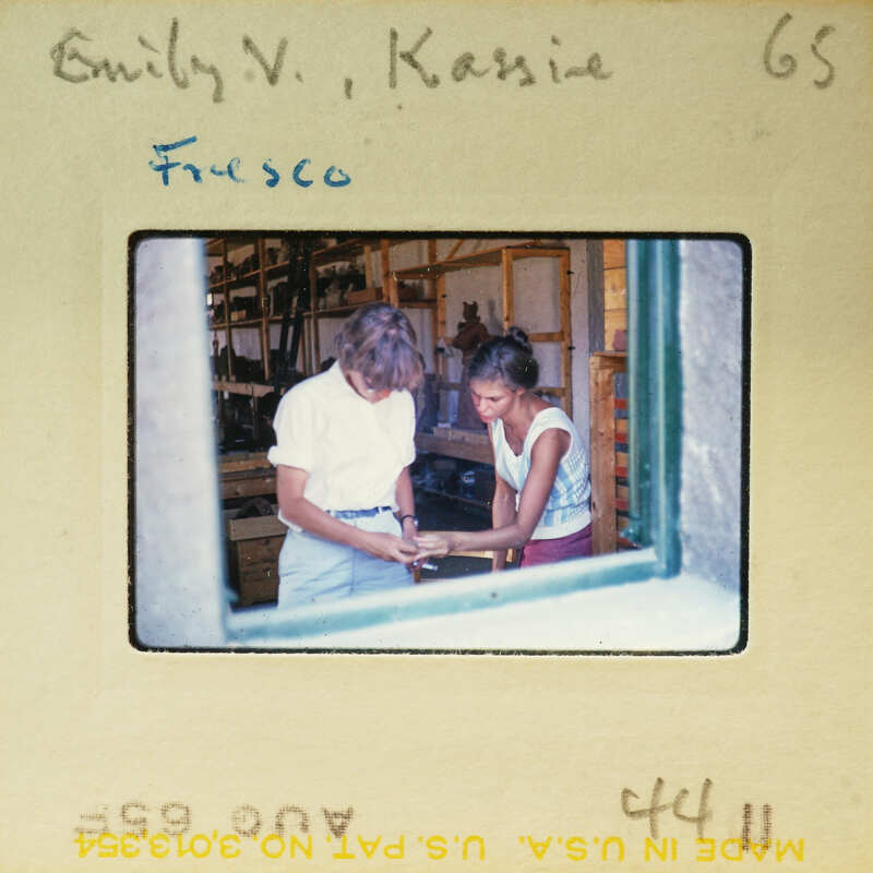 Two people looking at a piece of paper together.