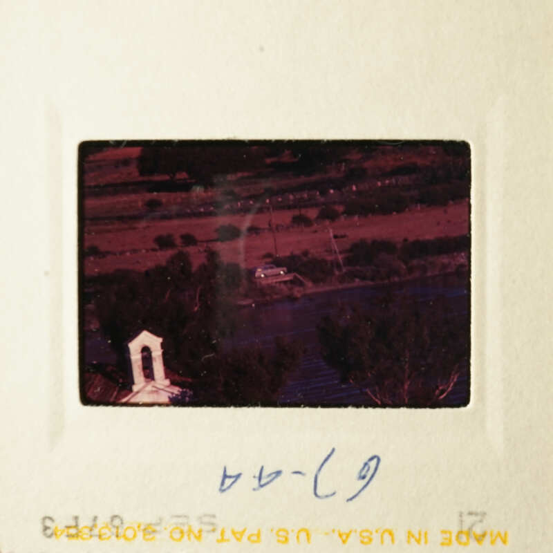 The image shows a black and white photo of a church with a steeple, taken from an elevated perspective.