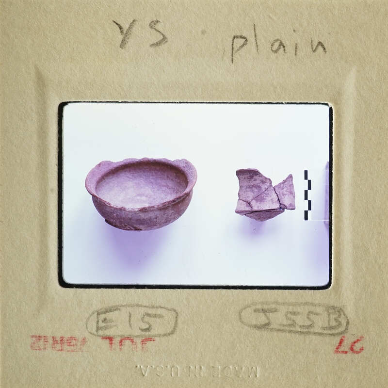 A photograph of an ancient bowl and fragments, possibly from a historical site.