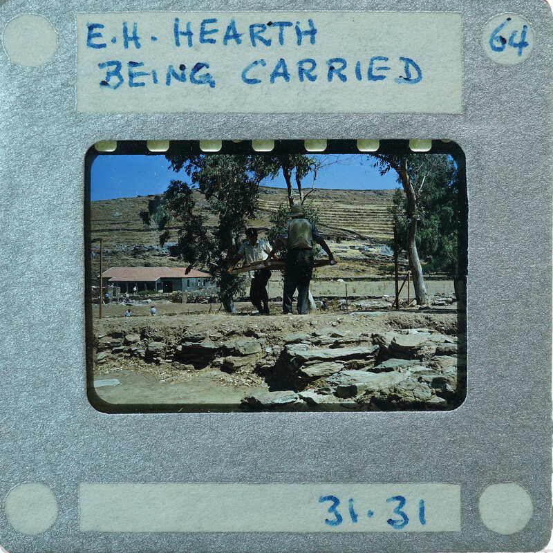 A vintage film strip showing a group of people carrying a hearth, and a building with mountains in the background.