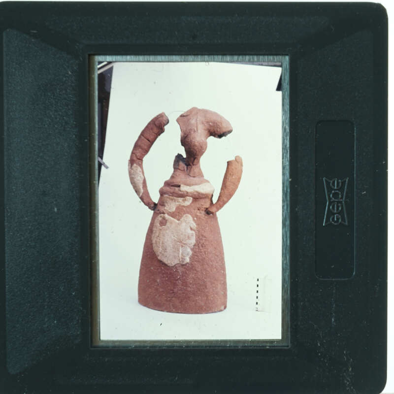 Partially restored figurine on white background.