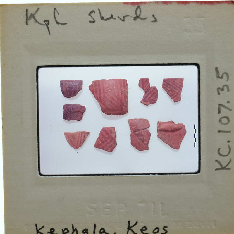 A collection of small, red-colored ceramic shards on a white background.