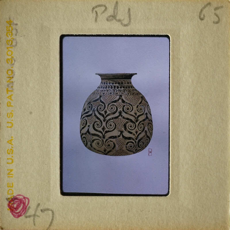 An antique vase with intricate designs on display.