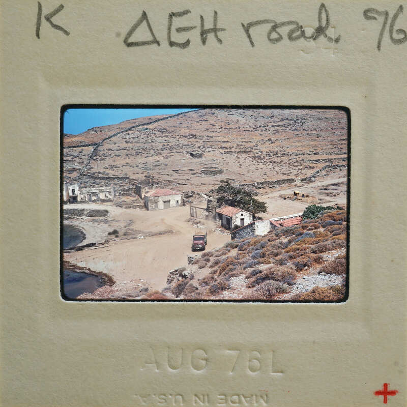 Old photograph of a village with dirt roads and stone houses, taken on August 7, 1976.