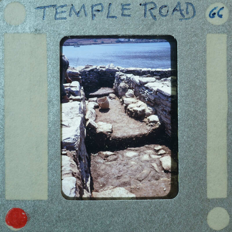 Parallel wall with surface between them and water in the background.