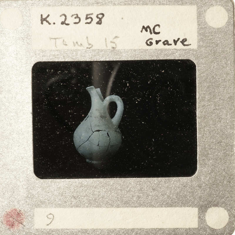 A black and white photograph of a cracked vase on a film strip with handwritten notes.
