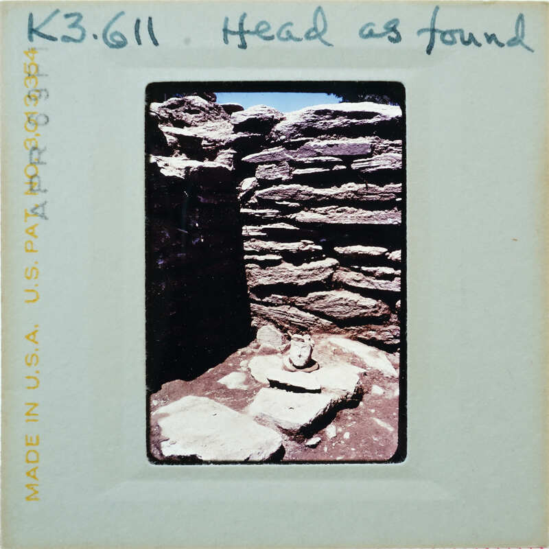 Stone walls and floor with terracotta head on floor.