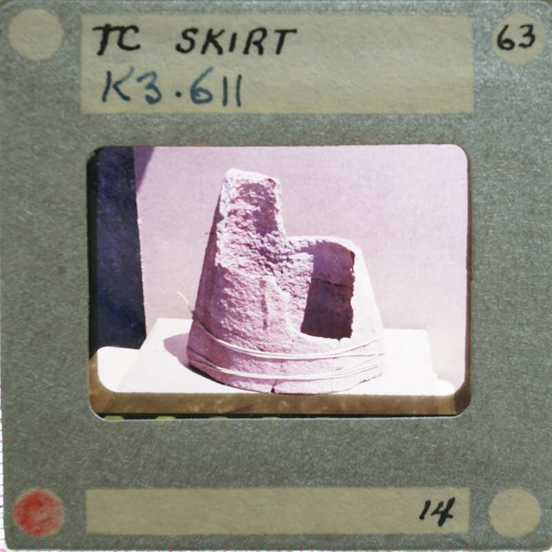Fragments of terracotta skirt of figurine upright.