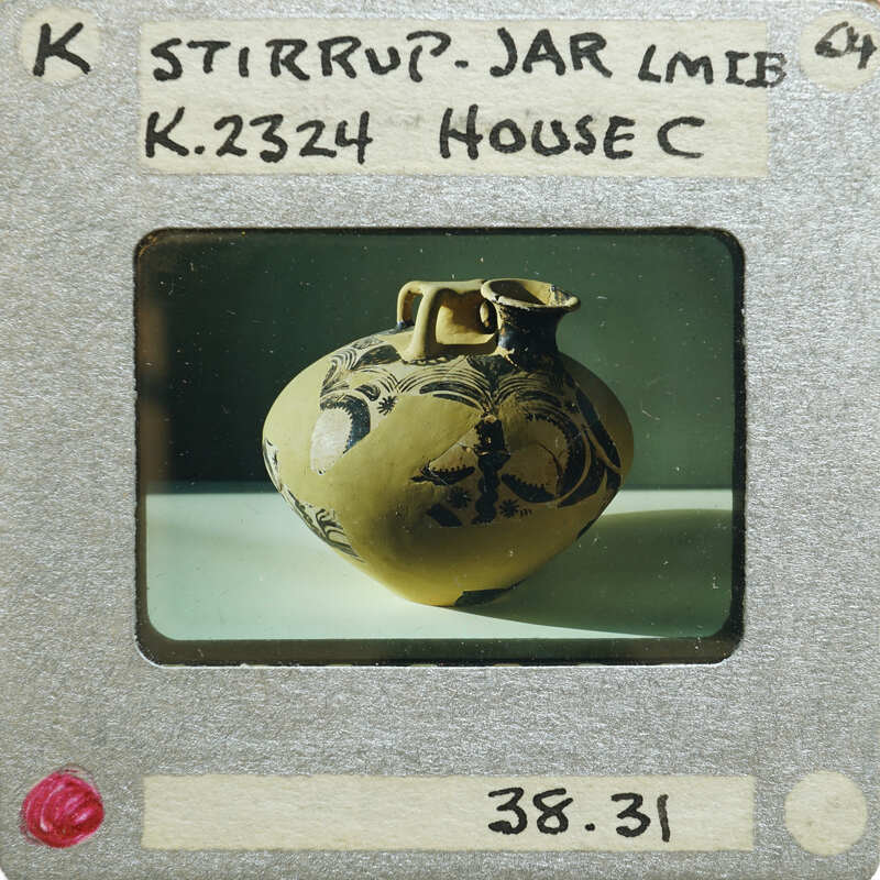 Stirrup jar vase (K.2324) side view on table.