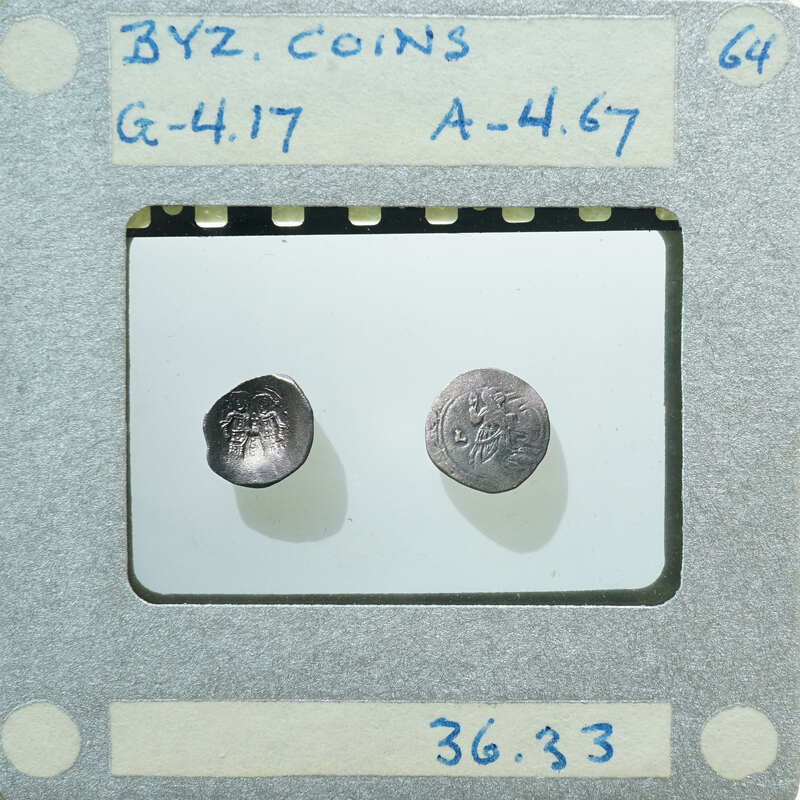 Two small coins displayed on a white surface with labels and numbers written around them.