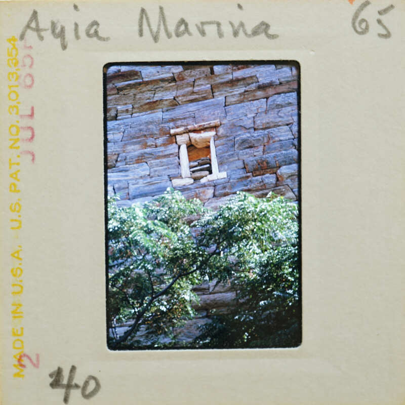 A slide of a stone structure with foliage and a small window, labeled "Aiya Marina" on the front.