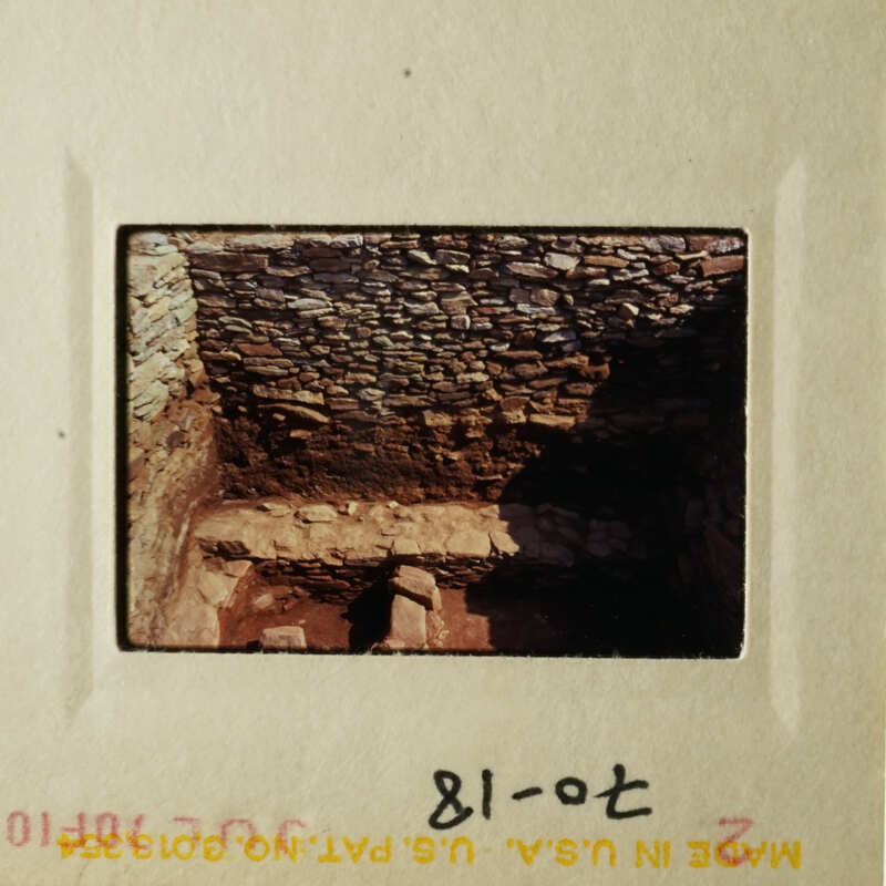 This photo shows an ancient stone structure, possibly a cave or underground chamber, with a low ceiling and a dark interior.