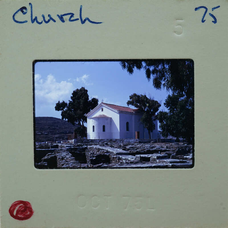 A vintage photo of a church with trees and ruins in the background, dated October 1976.