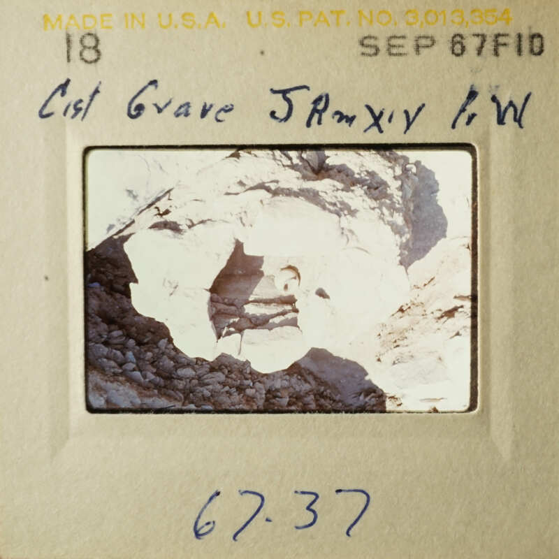 This is an image of a vintage photograph placed on a display card, featuring a rock formation with a caption that reads "Cist Gave Janyx WW".