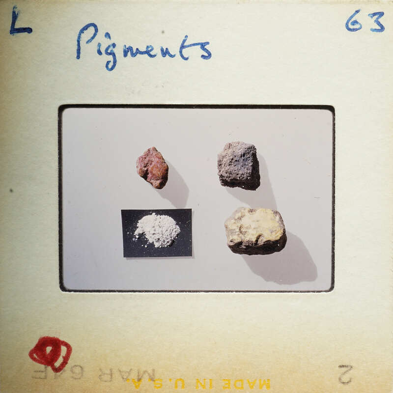 Four rocks with different colors and textures, displayed on a white surface with labels.