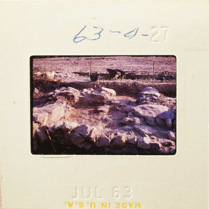 Ancient ruins with stone walls and dirt ground, photographed on film.