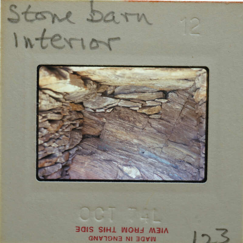Slide showing an interior view of a stone structure with layers of rock and soil.