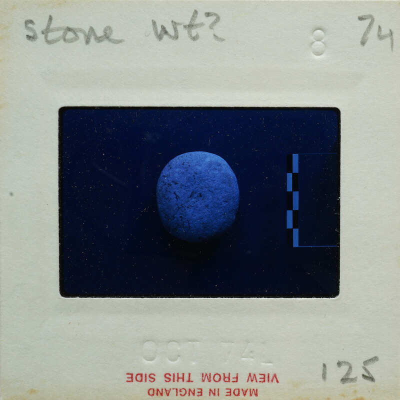 A photograph of a blue, spherical object with an old-fashioned film strip border.