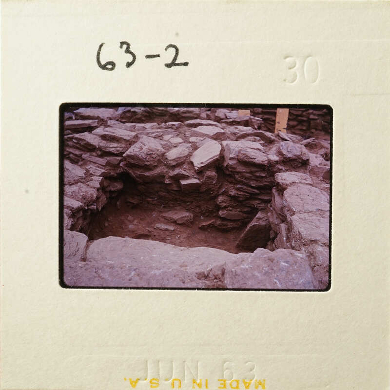 Ancient ruins with exposed stone foundations and walls, possibly part of an archaeological site.