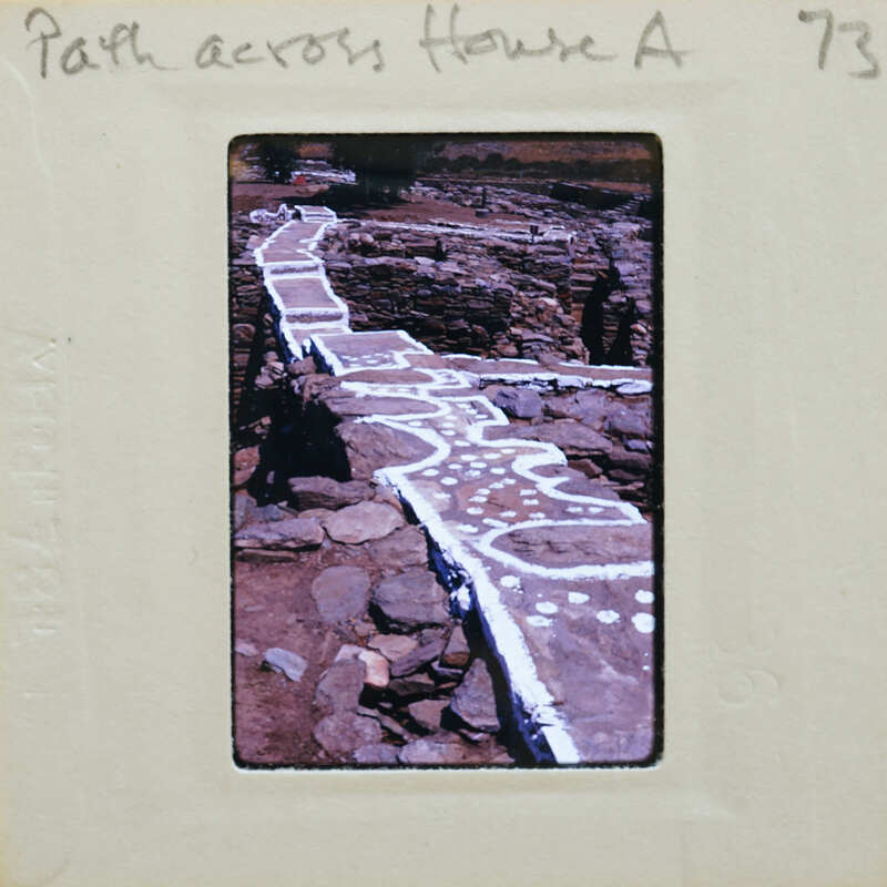 Ancient stone pathway with markings, possibly a Roman road or similar historical site.